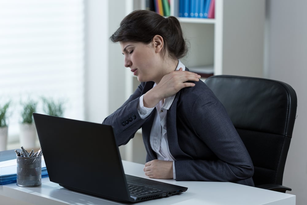 A patient struggling with neck pain, searching for a physical therapist in Atlanta, GA