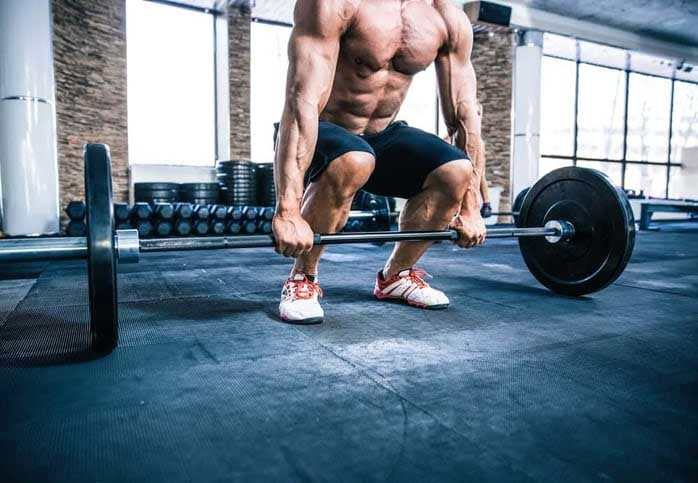 Closeup-portrait-of-a-muscular-man-workout-with-barbell-at-gym-1