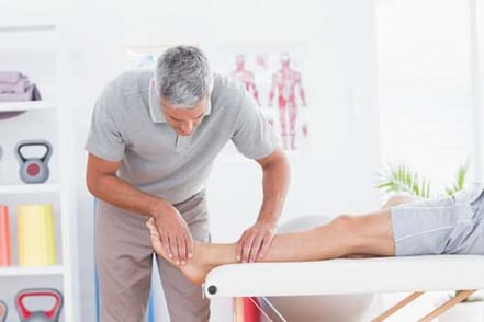 Man having leg massage in medical office