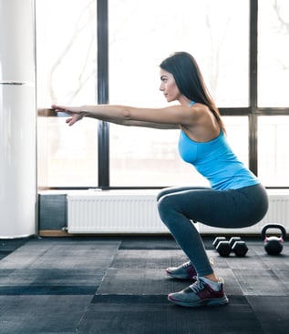 Woman doing squats for pelvic floor health