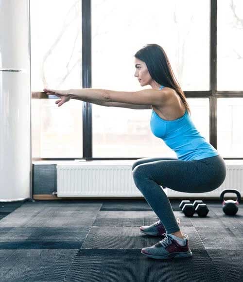 Side-view-portrait-of-a-young-woman-doing-squats-at-fitness-gym-Oct-12-2022-11-20-25-12-AM-1