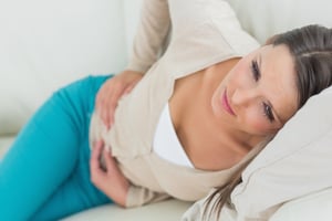 Person holding abdomen because of bladder pain 