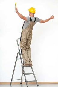 Worker with yellow helmet  falling from aluminium ladder