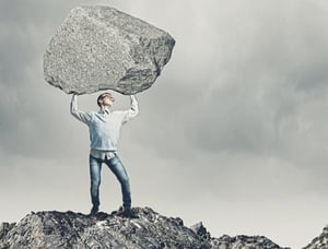 Young-strong-man-holding-huge-stone-above-head