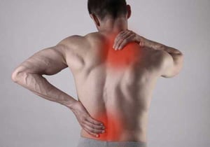 Man suffering from back spasms