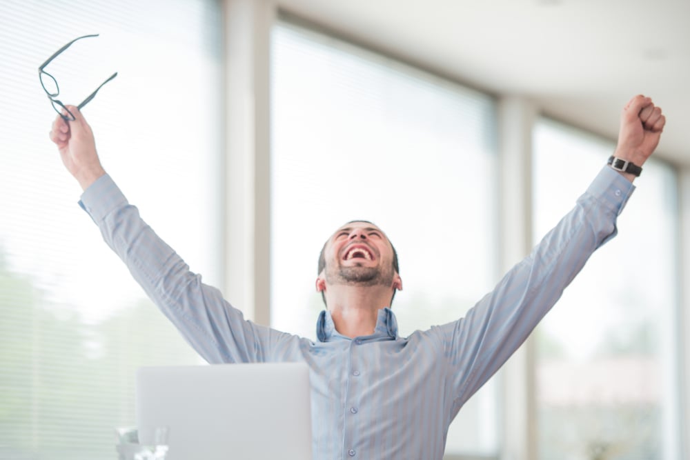 A man lifting his arms overhead